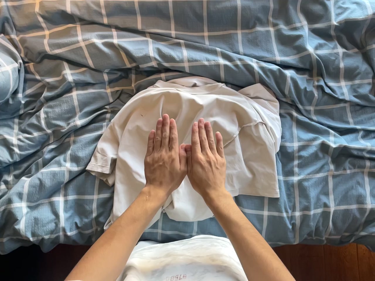 Folding Clothes in a Bedroom first-frame poster